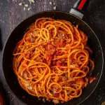 Spaghetti all’Amatriciana with crispy guanciale, tomatoes, and Pecorino Romano